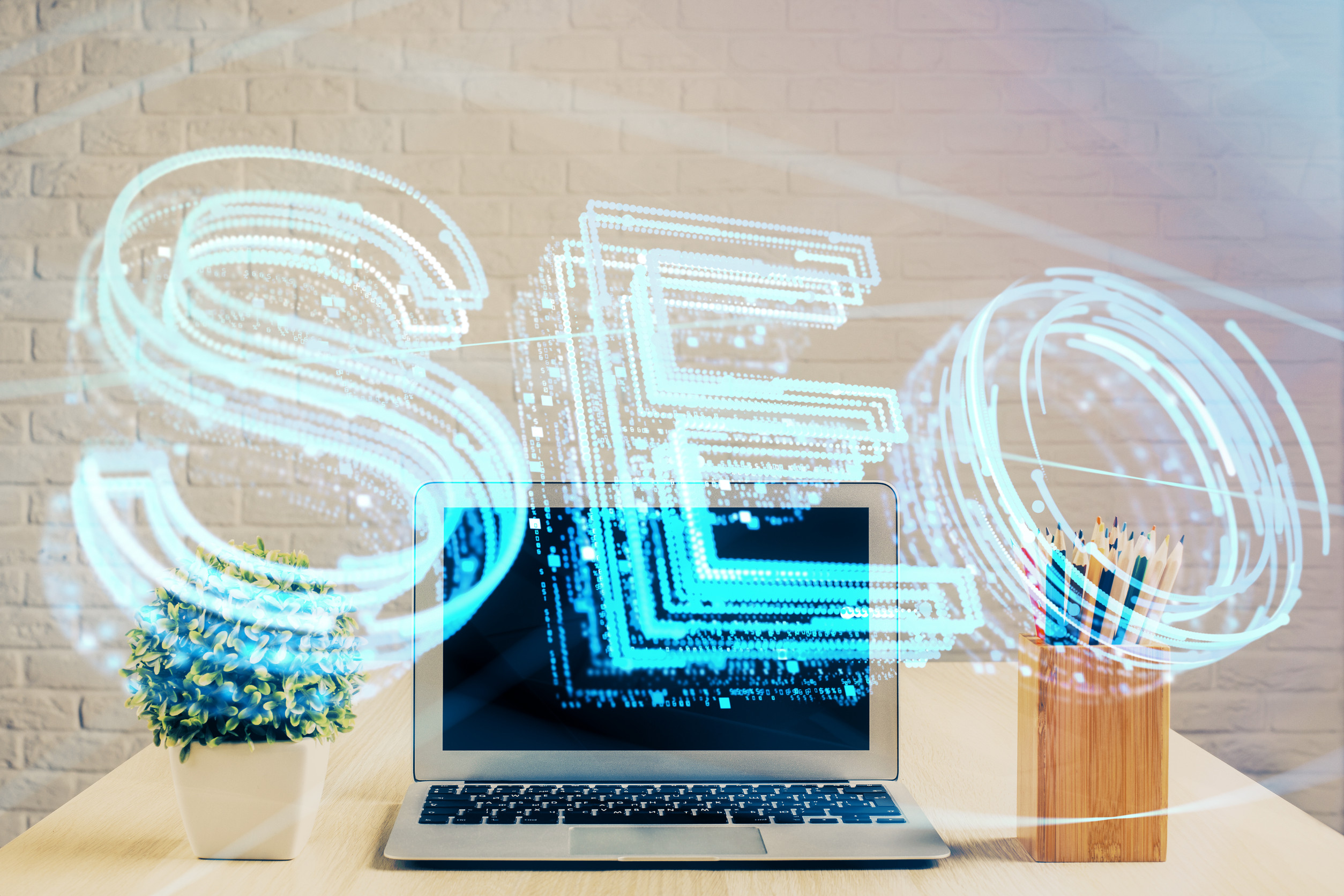 A laptop on a desk with a potted plant and pencils, overlaid with a large, glowing digital "SEO" graphic, representing search engine optimization in a modern office setting.