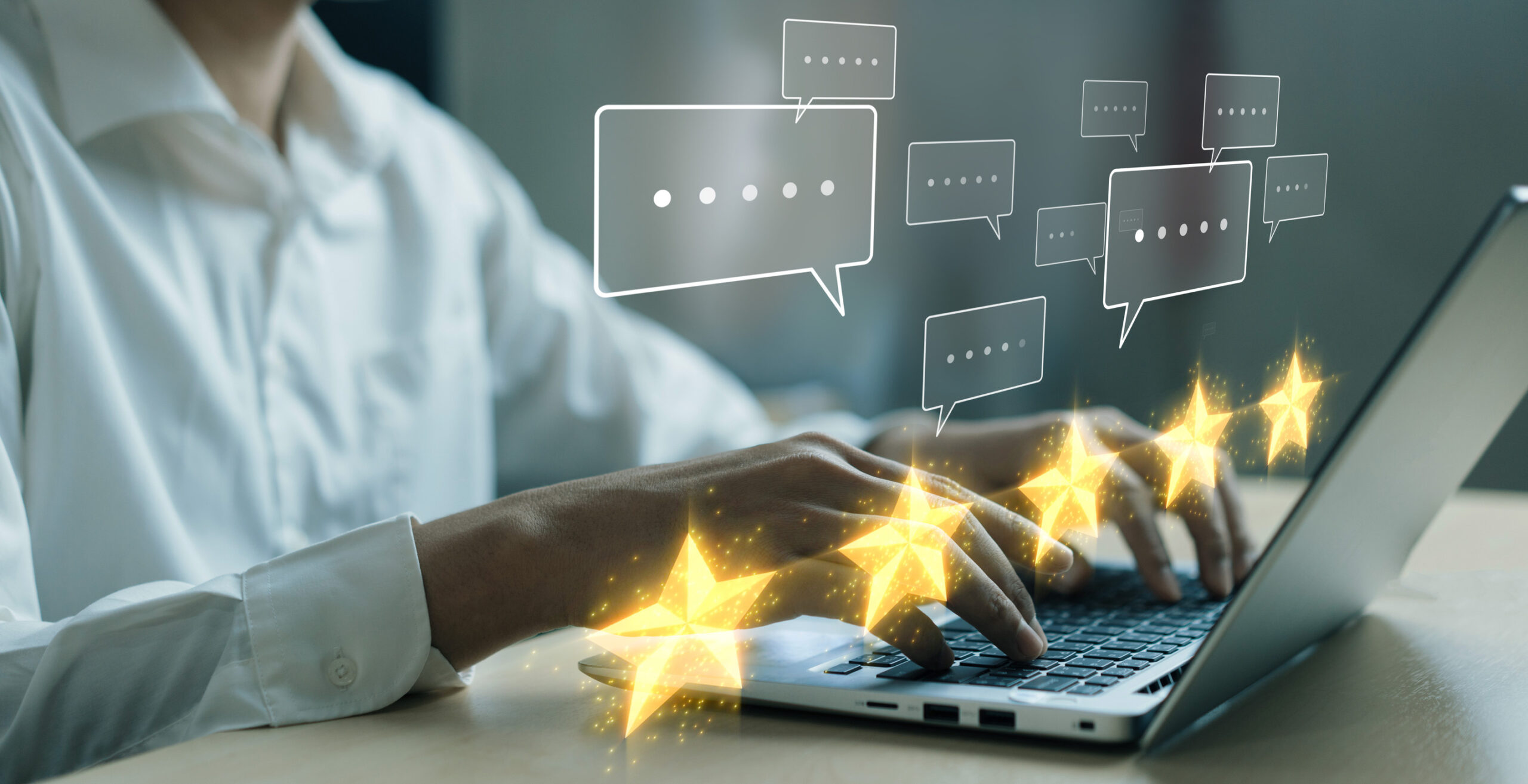 A person in a white shirt types on a laptop, with illustrated chat bubbles and five glowing golden stars above the keyboard, symbolizing explosive review growth or high customer ratings.